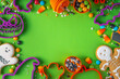 Leinwandbild Motiv Bright colorful Halloween gingerbread cookies and sweet background. Homemade biscuits with cookie cutters, sugar sprinkles and candies. High-colored Halloween treats flat lay top view copy space