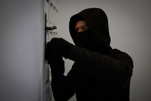 Thief Opening Door With Lock Picker.
