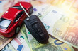euro money with red toy car and key for rent sell or insurance concept