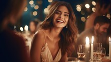 Beautiful Woman Enjoying While Having Dinner With Friends At Night Party.