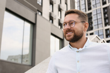 Poster - Portrait of handsome bearded man in glasses outdoors, space for text