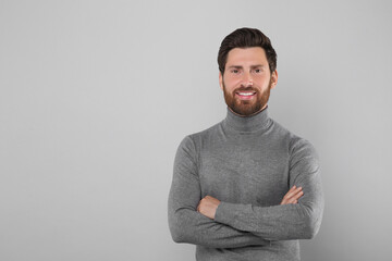 Wall Mural - Portrait of handsome man on light grey background, space for text