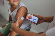 © Halfpoint - Boy with diabetes checking blood glucose level at home using continuous glucose monitor.