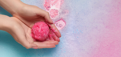 Wall Mural - Woman holding bath bomb over foam, closeup. Banner design