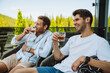 © Drobot Dean - Two male friends drinking whiskey while relaxing on terrace in mountains