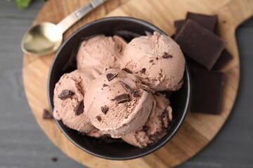 Wall Mural - Bowl with tasty chocolate ice cream on wooden board, flat lay