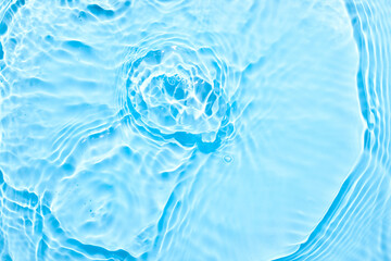 Wall Mural - Water blue surface abstract background. Waves and ripples texture of cosmetic aqua moisturizer with bubbles