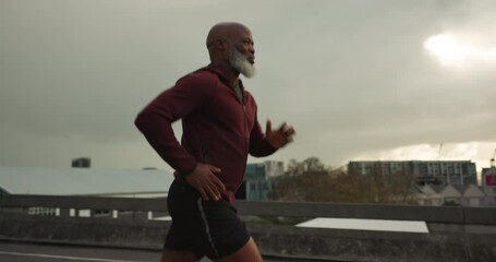 Poster - Senior African man, running and city in street, morning and vision for fitness, health and profile in retirement. Elderly runner, urban road and training with exercise, freedom or bridge in Cape Town