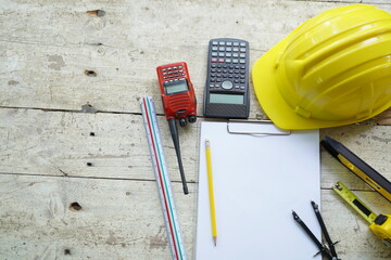 Set of professional construction tools and safety helmet on a work table. Top view. Tools. Various tools on a wooden table. engineering drawing Tools to work beyond architectural blueprints