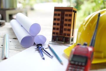 Set of professional construction tools and safety helmet on a work table. Top view. Tools. Various tools on a wooden table. engineering drawing Tools to work beyond architectural blueprints