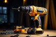 © wolfhound911 - Yellow rechargeable and cordless drill on a wooden table