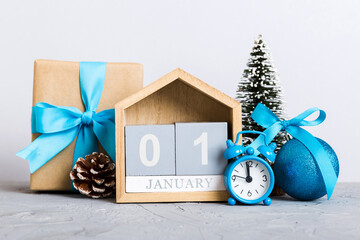 Wall Mural - 1 january. Christmas composition on colored background with a wooden calendar, with a gift box, toys, bauble copy space