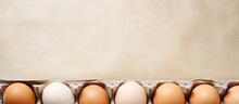 Organic Eggs In A Cardboard Carton On A Table Isolated Pastel Background Copy Space