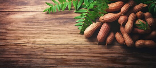 Fototapete - Selective focus and toned image of ripe tamarinds on a rustic wooden table with free copy space isolated pastel background Copy space