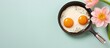 Fried egg sizzling on a black pan isolated pastel background Copy space