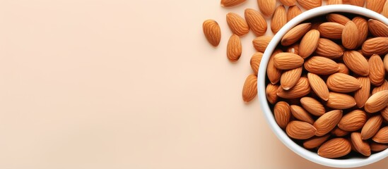 Poster - Almonds in a white bowl on a isolated pastel background Copy space with copy space have benefits for neutralizing free radicals preventing Alzheimers and repairing the body