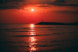 Fototapeta Morze - Dark red sunset by the sea. Sunset with pier background. Soft selective focus