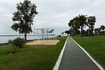 Canvas Print - Paisaje con carril bici y aparatos de gimnasia al aire libre.