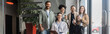 © LIGHTFIELD STUDIOS - diverse startup team looking at camera and posing in office, interracial business people banner