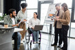 © LIGHTFIELD STUDIOS - diversity and inclusion, multiethnic business people planning project, disabled woman in wheelchair