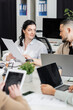 © LIGHTFIELD STUDIOS - asian man discussing working task with brunette female colleague in modern office, sharing ideas