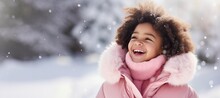 Happy Young African American Girl In A Pink Scarf In The Snow With Space For Copy
