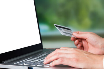 Business woman hands whit credit card on computer with blur office background