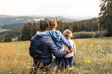 Father and his children in the field enjoying time together outdoors 