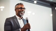 © Tierney - African american businessman giving a speech at conference