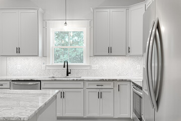 Wall Mural - Luxury White Kitchen Interior with Modern Design and Marble Stone Island with Stainless Steel Appliances