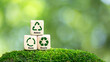 © tanakorn - icons related to reduce, reuse, recycle on green background blocks The concept of reduce, reuse, reuse symbols, ecological waste management and sustainable and economical lifestyles.