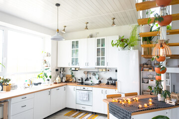 Wall Mural - The general plan of a light white modern rustic kitchen with a modular metal staircase decorated with potted plants. Interior of a house with homeplants