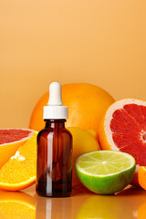 Wall Mural - Glass bottle with essential citrus oil on orange background