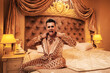 Rich and eccentric man dressed in a shimmering golden suit in a royal, luxurious suite