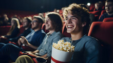 Cheerful Young Man Watching Movie At Cinema And Eating Popcorn