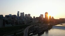Stone Arch Bridge And St. Anthony Falls Visitor Center During Sunset In Minneapolis City, Minnesota USA. Aerial Shot