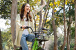 © MIND AND I - Happy woman riding bicycle at park.