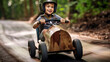 Young boy kid participating in a competitive soapbox derby race. He's behind the wheel of his homemade racer, speeding down a steep hill with determination and a thrill for speed.