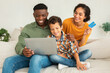 © Prostock-studio - Diverse Family Shopping Online Using Laptop And Credit Card Indoor