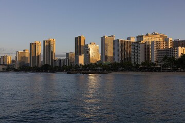 Canvas Print - City with tall buildings in the distance near the water