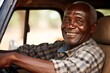 © Dangubic - Smiling African Man Behind the Wheel of a Car. generative AI