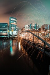 Wall Mural - Motion blur effect of glowing light trails on a night downtown background