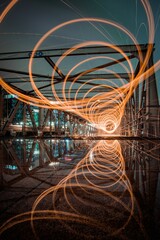 Wall Mural - Motion blur effect of glowing light trails on a night downtown background