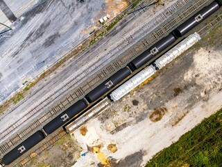 Poster - Aerial view of a long cargo train near a farm in Delaware on a sunny day