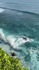 Poster - Vertical aerial view of beautiful blue crashing ocean waves