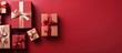 © AkuAku - Arranged gift boxes with ribbons seen from above on a red tabletop