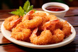 © chandlervid85 - fried coconut shrimp on wooden table. Close up