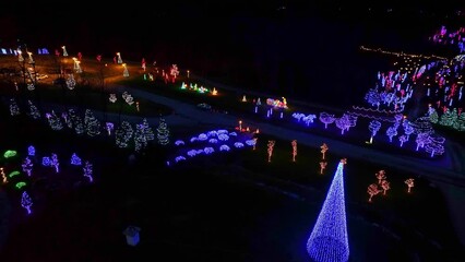 Canvas Print - Drone View of a Large Christmas Display, with Many Colored LED lights on Tree and Shrubs