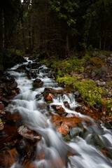 Poster - Long exposure of a stream of water winding its way through a rocky landscape