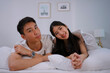 © Suney - Young couple together in bedroom with dog.
